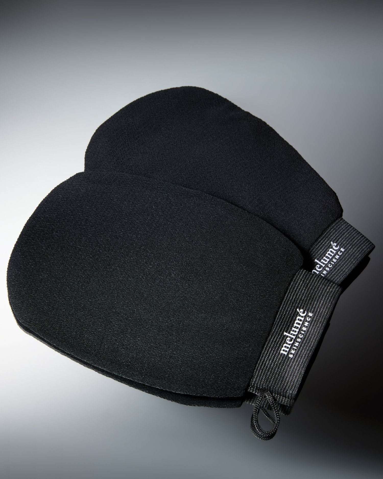 Black body gloves with a rayon photographed on a dark gray to black gradient background.