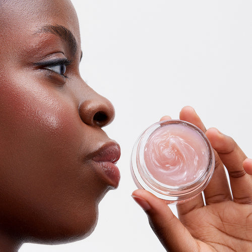 Carica immagine 1 in visualizzazione galleria. image mood of model holding glossy lip line eraser next to her full lips.