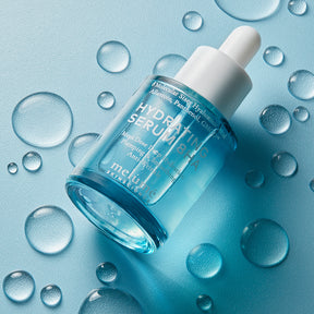 image mood of hydrating serum laying flat on floor with droplets around it
