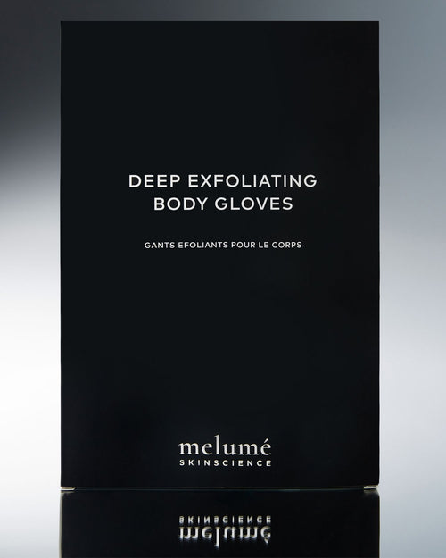 Load image 1 in gallery view. Melumé Skincare Deep Exfoliating Body Gloves packaging box in matte black with white text, shown against a dark gray gradient background with a reflection below.